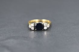 An 18ct gold sapphire and diamond set ring, the central oval sapphire measuring approximately 1ct,