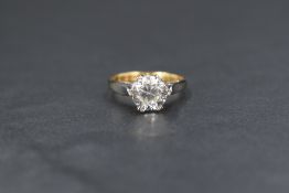 An 18ct gold white zircon set solitaire ring, the round brilliant cut zircon in a six double claw