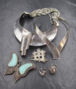 A large silver statement cuff necklace, along with two silver rings, a turquoise, garnet and