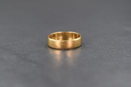 An 18ct gold band, of plain rounded form, marked 750, ring size L-M, 3.2g