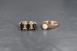 A 9ct gold sapphire trio ring, having two pairs of interspersing diamond chips, all in a claw and