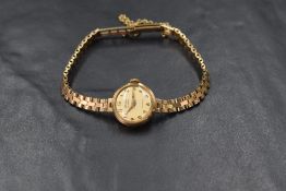 A ladies 1960's 9ct gold wrist watch by Majex having an Arabic numeral dial to champagne face in a