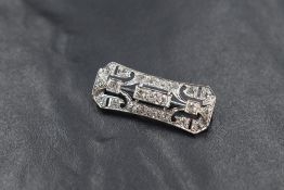 An Art Deco white metal and diamond brooch having twenty three old cut diamonds in an open white