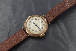 A yellow metal presumed gold cased wristwatch, the cream dial having Arabic numerals, on a leather