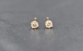 A pair of 18ct gold diamond solitaire stud earrings, each stone being approx 0.125ct in 4 claw set