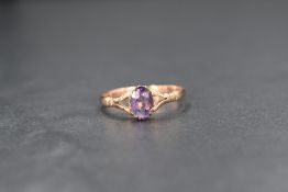 A 9ct rose gold amethyst set solitaire ring, the oval cut amethyst measuring approximately 0.75ct,