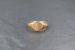 A 9ct gold heart signet ring, the heart panel having decorative scroll engraving to one side, marked