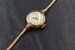 A 9ct gold Buren Grand Prix wristwatch, the champagne dial with Arabic numerals on a 9ct gold