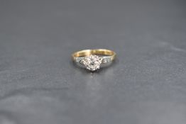 An 18ct gold and diamond solitaire ring, the round brilliant cut diamond measuring approximately 0.