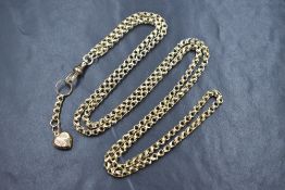 A yellow metal fancy link muff chain bearing plaque stamped 9ct having dog clip clasp and heart