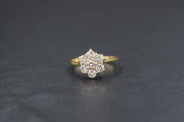 An 18ct gold diamond set cluster ring, the floral motif cluster having a total diamond weight of