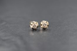 WITHDRAWN A pair of yellow metal presumed gold diamond solitaire earrings, the diamonds measuring