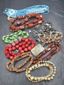 Ten strings of beads of assorted forms including wooden beads, hematite, polished stone, woven