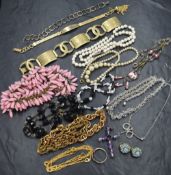 A selection of vintage costume jewellery including gold plated bracelets, necklaces, clip