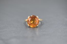 A 9ct gold citrine set solitaire ring, the citrine measuring approximately 5ct in a four claw raised