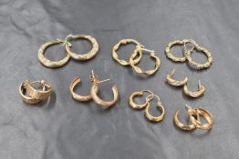 A selection of 9ct gold and yellow metal hoop earrings of various forms, some marked 375,