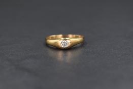 A yellow metal presumed gold diamond gypsy style ring, the central old cut diamond in a bezel