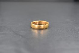 A 22ct gold wedding band of plain form, marked 22 with hallmarks, size O & approximately 6.3g