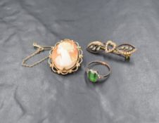 A small conch shell cameo brooch depicting a maiden in profile in a decorative 9ct gold mount, a