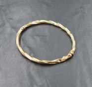 A yellow metal hinged twist bangle stamped 585, badly damaged, approx 6.8g