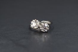 An 18ct white gold diamond Tu Et Moi ring, the two round cut diamonds measuring approximately 1.