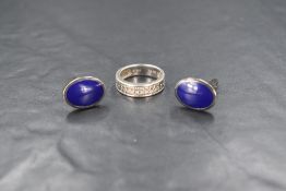 A pair of silver and enamel cufflinks, the oval panels having blue enamel, along with a silver