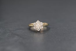 A 9ct gold diamond daisy flower head cluster ring, the seven diamonds totalling approx 0.5ct, size
