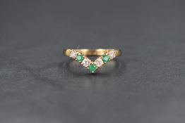 A 9ct gold wishbone ring having three green chrysopase stones interspersed by four clear paste
