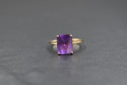 A 9ct gold amethyst set ring, the emerald cut amethyst being approx 2ct in a four claw mount on a