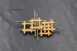 An Italian white & yellow metal brooch of architectural design, stamped 750, approximately 53mm x