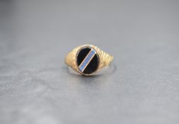 A 9ct gold gents signet ring, having an oval onyx panel with blue stone and gold diagonal inlay