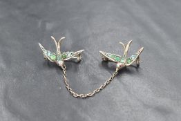 A silver brooch formed from two independent turquoise set swallows united by a chain, 4.4g