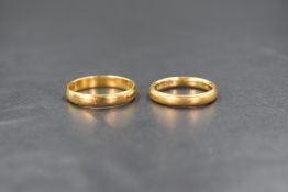 Two 22ct gold weddig bands of plain form, marked 22 with hallmarks, size N & I, approximately 7.1g
