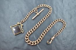 A 9ct rose gold watch chain with T bar marked 375, and carnelian stone 9ct gold mounted fob,