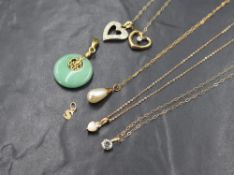 A small selection of yellow metal jewellery including four pendants with chains plus two loose