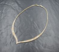 A 1980's 9ct three tone gold shaped collarette necklace with concealed box clasp, marked 375,
