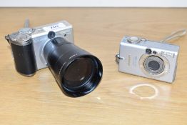 Two Canon digital cameras. A Canon Powershot A80 and an Ixus 400