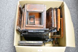 A box of mahogany field camera parts