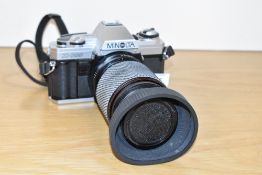 A Minolta X300 camera with Tokina 1:4-5,6 70-210mm lens