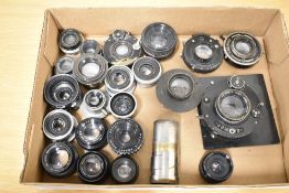 A tray of twenty three black painted and shuttered lenses