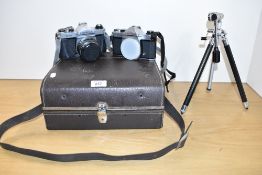 Two Pentax K1000 camera bodies one with a SMC Pentax 1:2 55mm lens with hard camera case connector