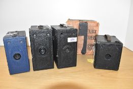 Four box cameras. An Ensign E29, a 1920's APeM box camera, and two H-B Ensign cameras one in