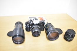 A Canon A1 camera with a Rubimat CCT 1:2,8 28mm lens, a Canon Zoom FD 1;4 70-210mm, a Canon Zoom