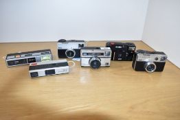 Seven Instamatic cameras. A Kodak 277X, a Kodak Instamatic 33, a Photosport Highlight tele, a