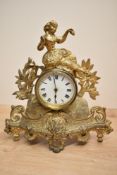 A late 19th / early 20th century gilt metal mantel clock in the classical style having acanthus leaf