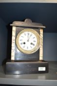 A late 19th century black slate mantel clock, having enable dial, Roman numerals and single bell