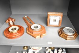 An early 20th century oak barometer having temperature gauge, L45cm, sold together with 3 other