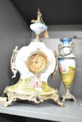 A Franz Hermle (Germany) porcelain mantel clock and garniture, hand coloured with playful cherbs