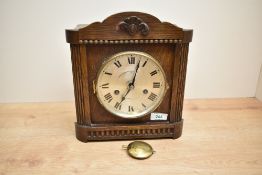 A early 20th century 'H.A.C Wuttem Berg' oak cased 8 - day mantel clock having single gong strike,