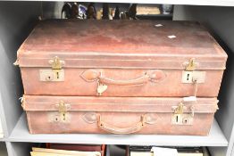 A pair of early 20th century brown leather travel cases, L65cm, ( 2 )